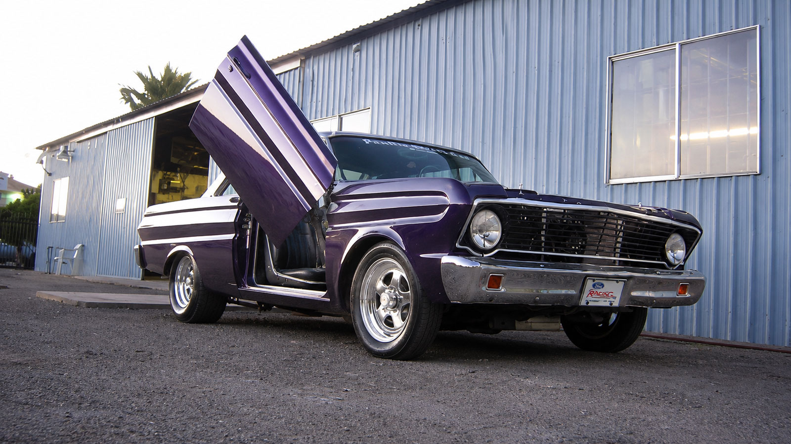 Classic car with vertical Lambo-style doors open at JEP Autoworks Hemet CA